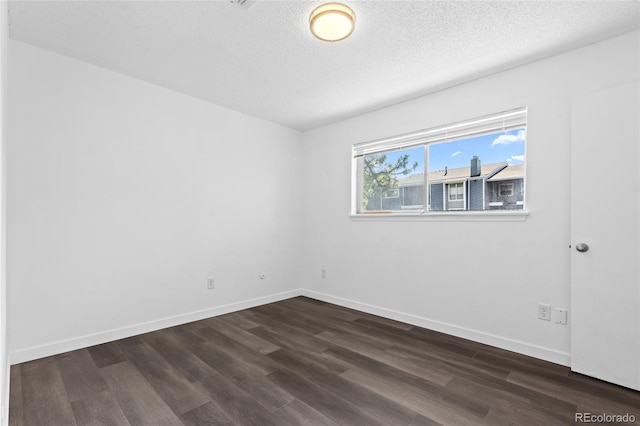7220 S Gaylord St Unit G17, Littleton, CO 80122 - unfurnished room with dark wood-style flooring, baseboards, and a textured ceiling