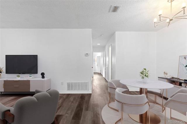 7220 S Gaylord St Unit G17, Littleton, CO 80122 - dining room featuring a chandelier, wood finished floors, a textured ceiling, baseboards, and recessed lighting