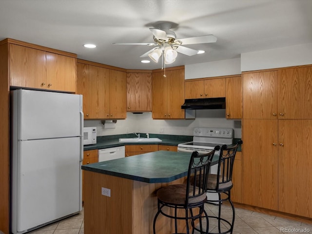 5660 S Eaton St, Littleton, CO 80123 - kitchen featuring white appliances, under cabinet range hood, dark countertops, ceiling fan, and light tile patterned floors