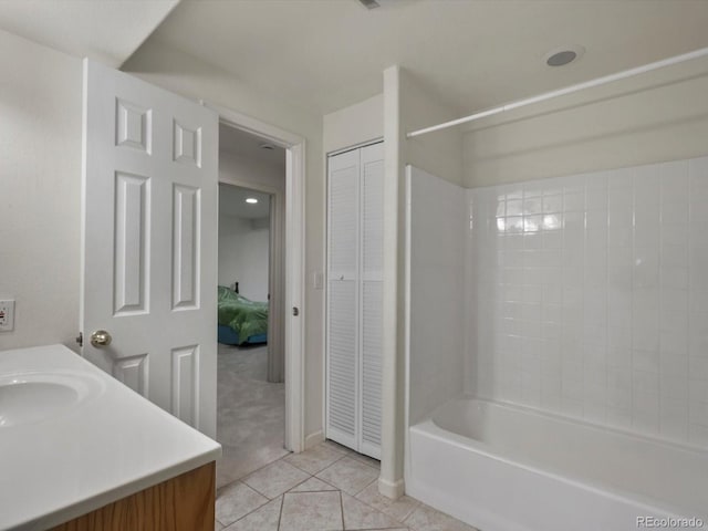 5660 S Eaton St, Littleton, CO 80123 - bathroom with vanity, tile patterned flooring, washtub / shower combination, a closet, and ensuite bath