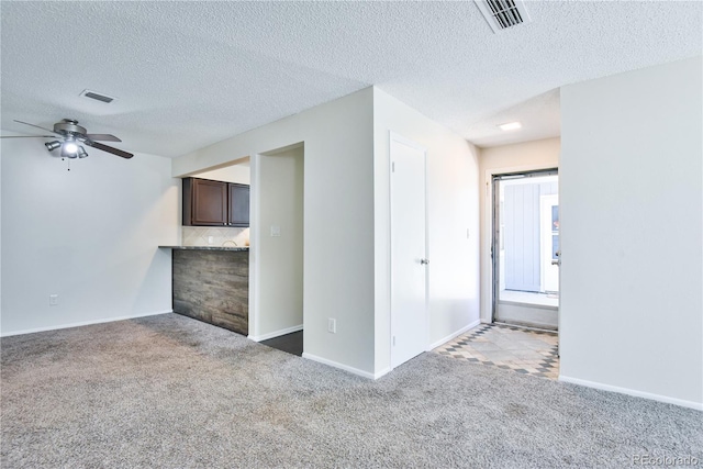 7185 S Gaylord St Unit A, Littleton, CO 80122 - unfurnished living room with carpet, a ceiling fan, baseboards, and a textured ceiling