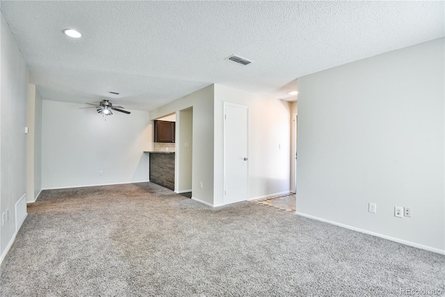 7185 S Gaylord St Unit A, Littleton, CO 80122 - unfurnished living room with carpet floors, ceiling fan, a textured ceiling, and baseboards