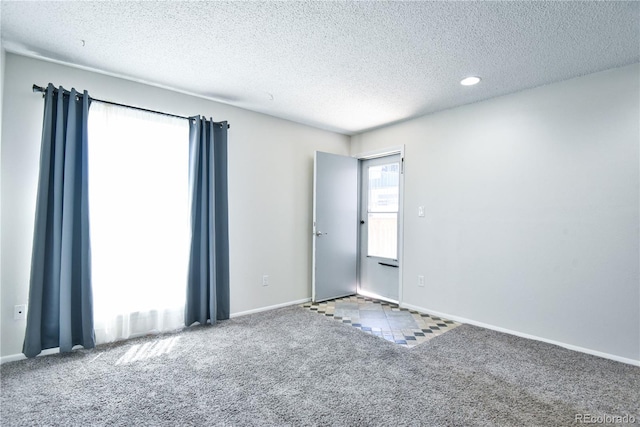 7185 S Gaylord St Unit A, Littleton, CO 80122 - carpeted empty room featuring a textured ceiling and baseboards