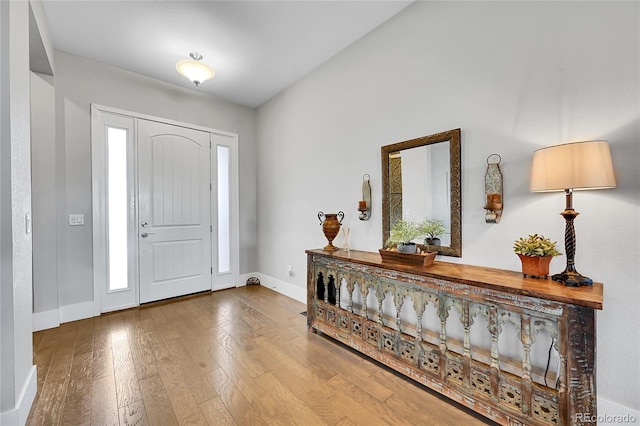 entryway featuring baseboards and hardwood / wood-style flooring