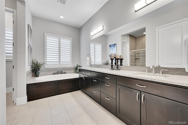 bathroom featuring double vanity, visible vents, a stall shower, a sink, and a bath