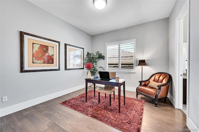 office space with wood finished floors and baseboards