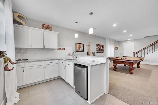 kitchen with recessed lighting, light carpet, a peninsula, a sink, and white cabinetry