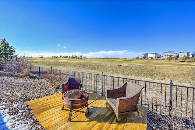 deck with an outdoor fire pit and fence