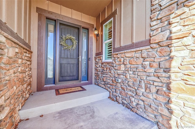 entrance to property featuring stone siding