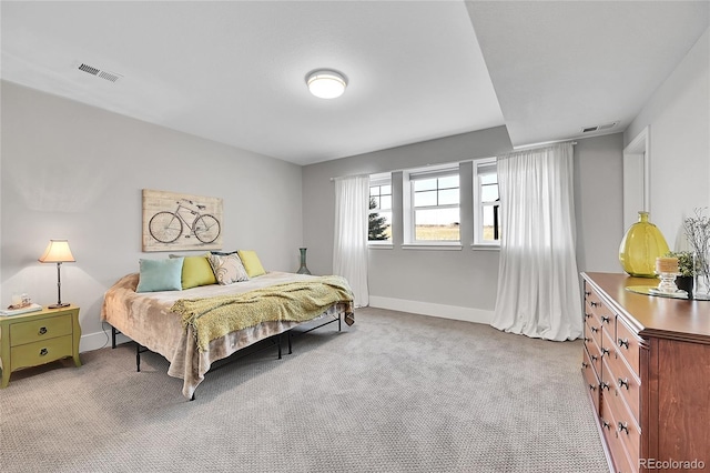 bedroom featuring carpet floors, visible vents, and baseboards