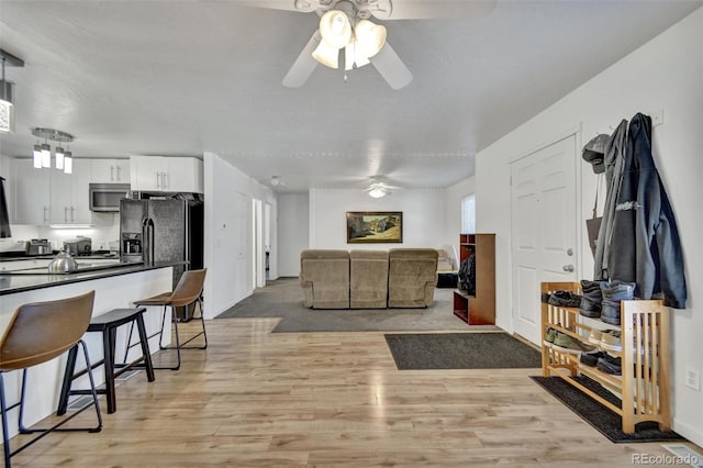 2279 S Lewiston St, Aurora, CO 80013 - living area with a ceiling fan and light wood-type flooring
