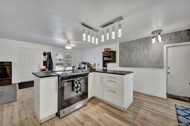 2279 S Lewiston St, Aurora, CO 80013 - kitchen featuring electric stove, dark countertops, light wood-style flooring, and white cabinetry
