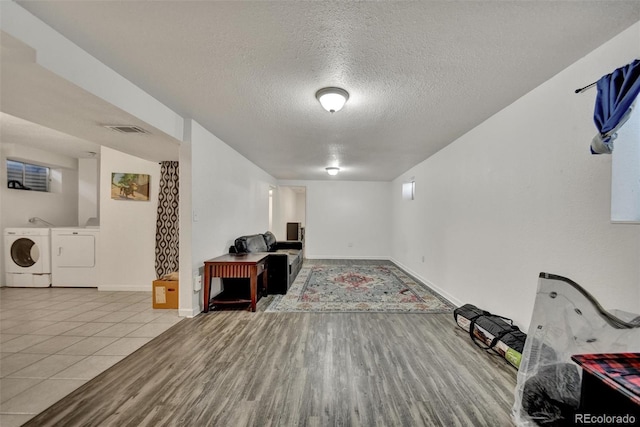 2279 S Lewiston St, Aurora, CO 80013 - unfurnished living room featuring independent washer and dryer, a textured ceiling, and wood finished floors