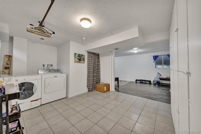 2279 S Lewiston St, Aurora, CO 80013 - washroom featuring independent washer and dryer, a textured ceiling, and light tile patterned floors