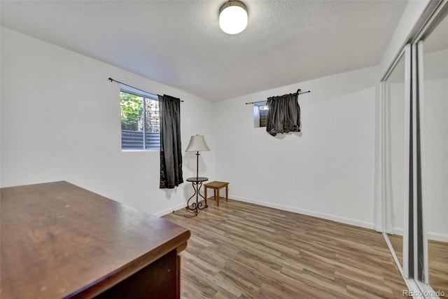 2279 S Lewiston St, Aurora, CO 80013 - living area featuring light wood-style flooring and a textured ceiling