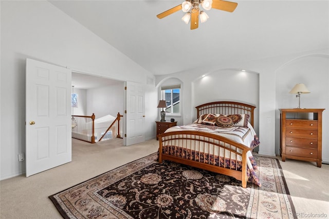 carpeted bedroom featuring ceiling fan and high vaulted ceiling