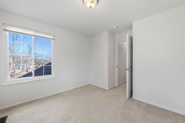 unfurnished room featuring light carpet