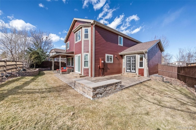 rear view of house featuring a yard and a patio area