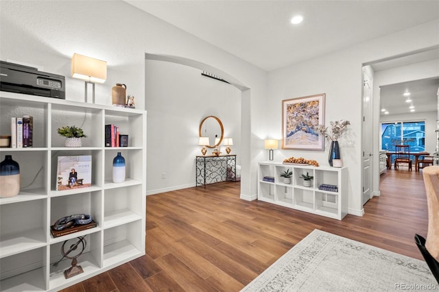 interior space with recessed lighting, wood finished floors, and baseboards