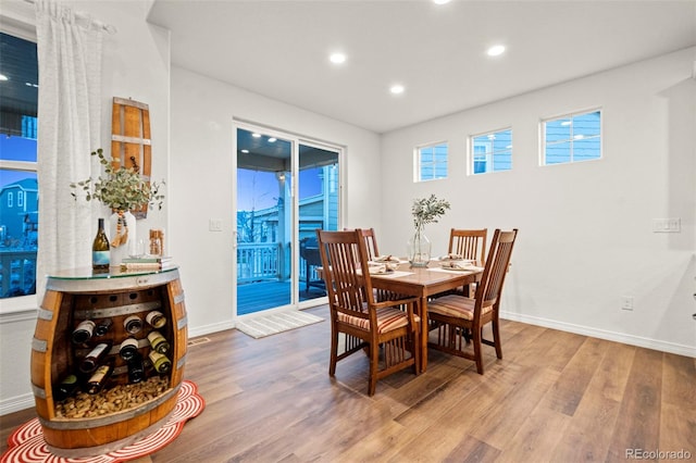 dining room featuring recessed lighting, wood finished floors, and baseboards