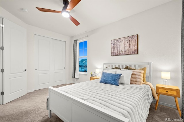 carpeted bedroom featuring baseboards, a ceiling fan, and a closet