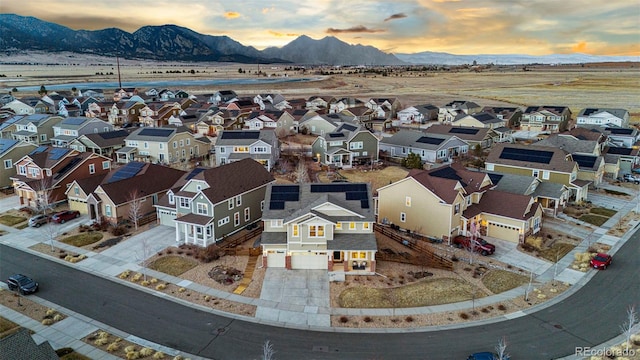 aerial view at dusk with a residential view and a mountain view