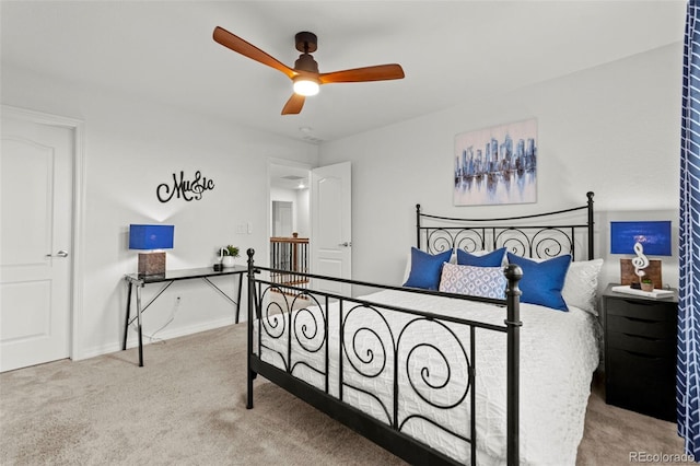 carpeted bedroom featuring ceiling fan and baseboards