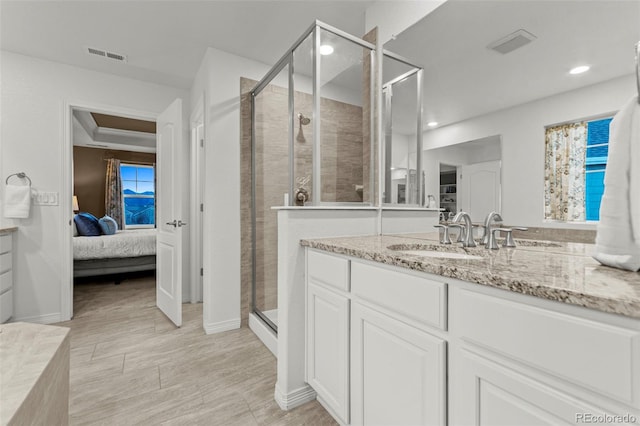 bathroom featuring a stall shower, visible vents, and vanity