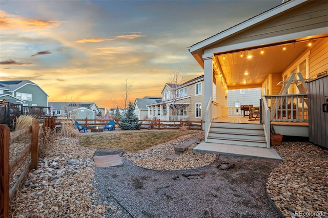 view of yard with a residential view, fence, and a wooden deck