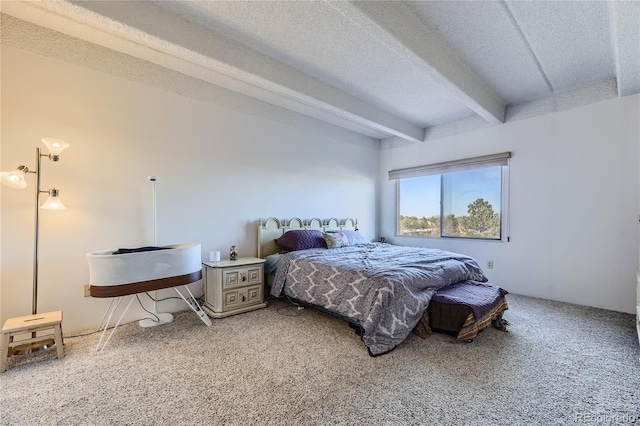 bedroom with beamed ceiling, carpet, and a textured ceiling