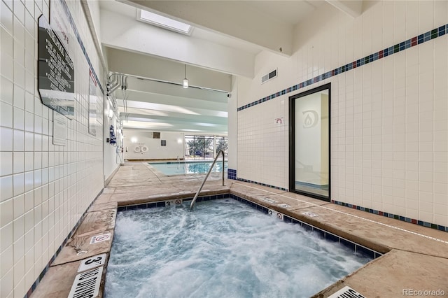 view of swimming pool with an indoor in ground hot tub