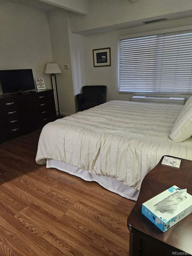 bedroom featuring dark hardwood / wood-style flooring