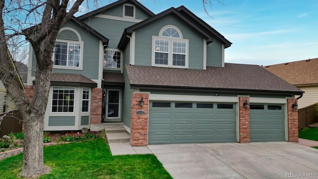 traditional-style house with a front yard, brick siding, driveway, and roof with shingles