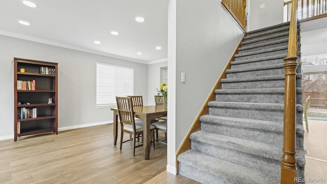 staircase featuring ornamental molding, baseboards, recessed lighting, and wood finished floors