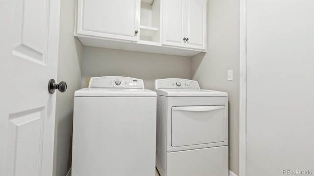 washroom featuring washer and dryer and cabinet space