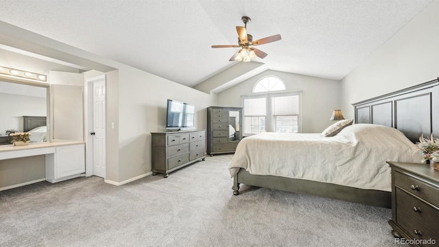 bedroom featuring vaulted ceiling, light carpet, baseboards, and a ceiling fan