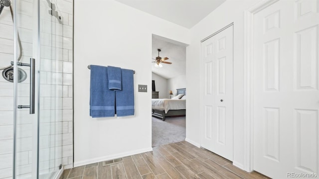ensuite bathroom with a shower stall, ensuite bathroom, visible vents, and a ceiling fan