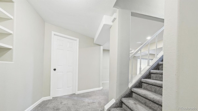 stairs with carpet and baseboards