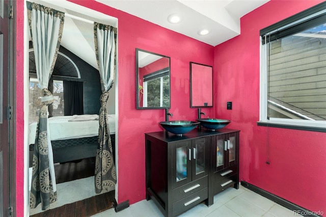 bathroom featuring vanity and vaulted ceiling