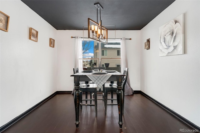 dining room featuring dark hardwood / wood-style floors and a chandelier