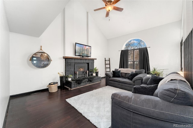 living room with ceiling fan, high vaulted ceiling, dark hardwood / wood-style floors, and a fireplace