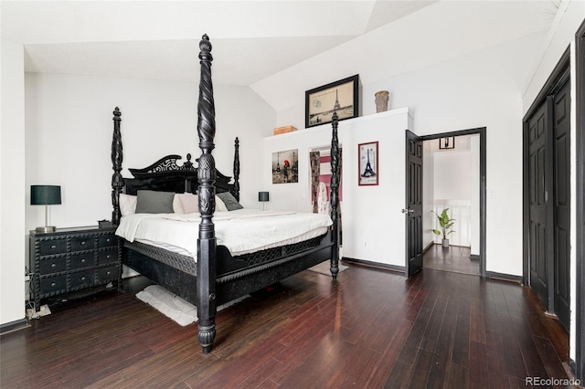 bedroom featuring dark hardwood / wood-style flooring and vaulted ceiling