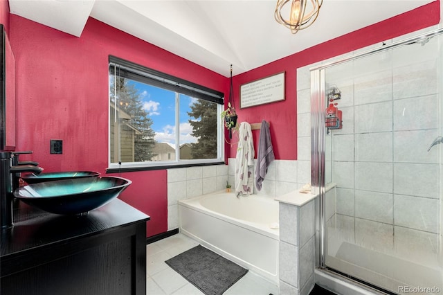 bathroom featuring vaulted ceiling, vanity, tile patterned floors, and plus walk in shower