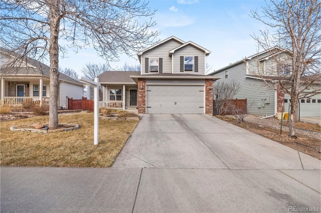 traditional-style house with concrete driveway, an attached garage, covered porch, fence, and brick siding