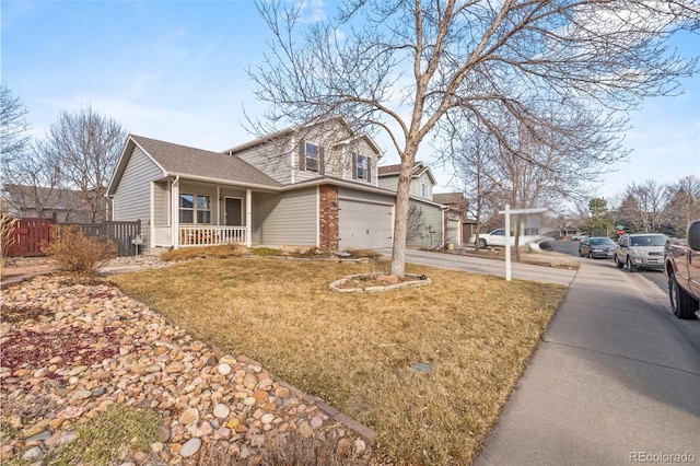 view of front of property with covered porch, a garage, fence, concrete driveway, and a front yard