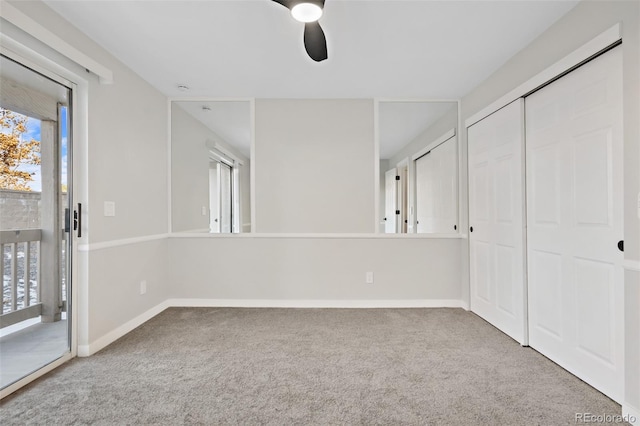 interior space with carpet, multiple windows, ceiling fan, and access to outside