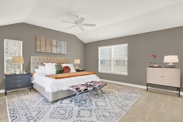 bedroom with vaulted ceiling, ceiling fan, multiple windows, and baseboards