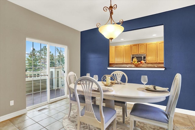 dining area featuring visible vents, baseboards, and light tile patterned floors