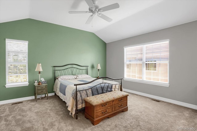 bedroom with lofted ceiling, baseboards, and light colored carpet