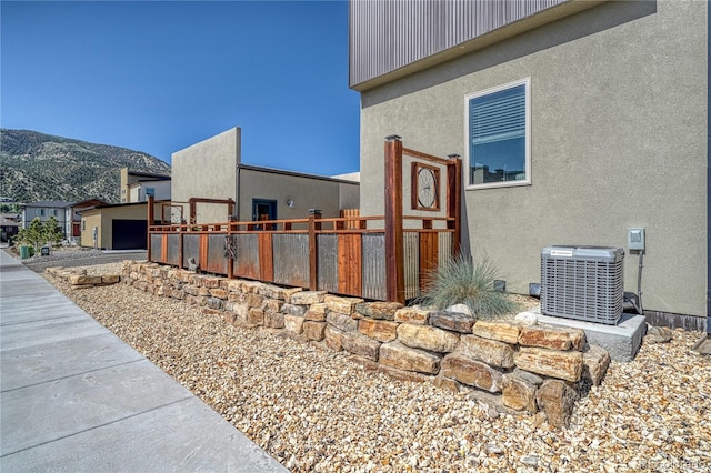 1139 Agate Ln, Poncha Springs, CO 81242 - view of side of property with cooling unit, a mountain view, and stucco siding